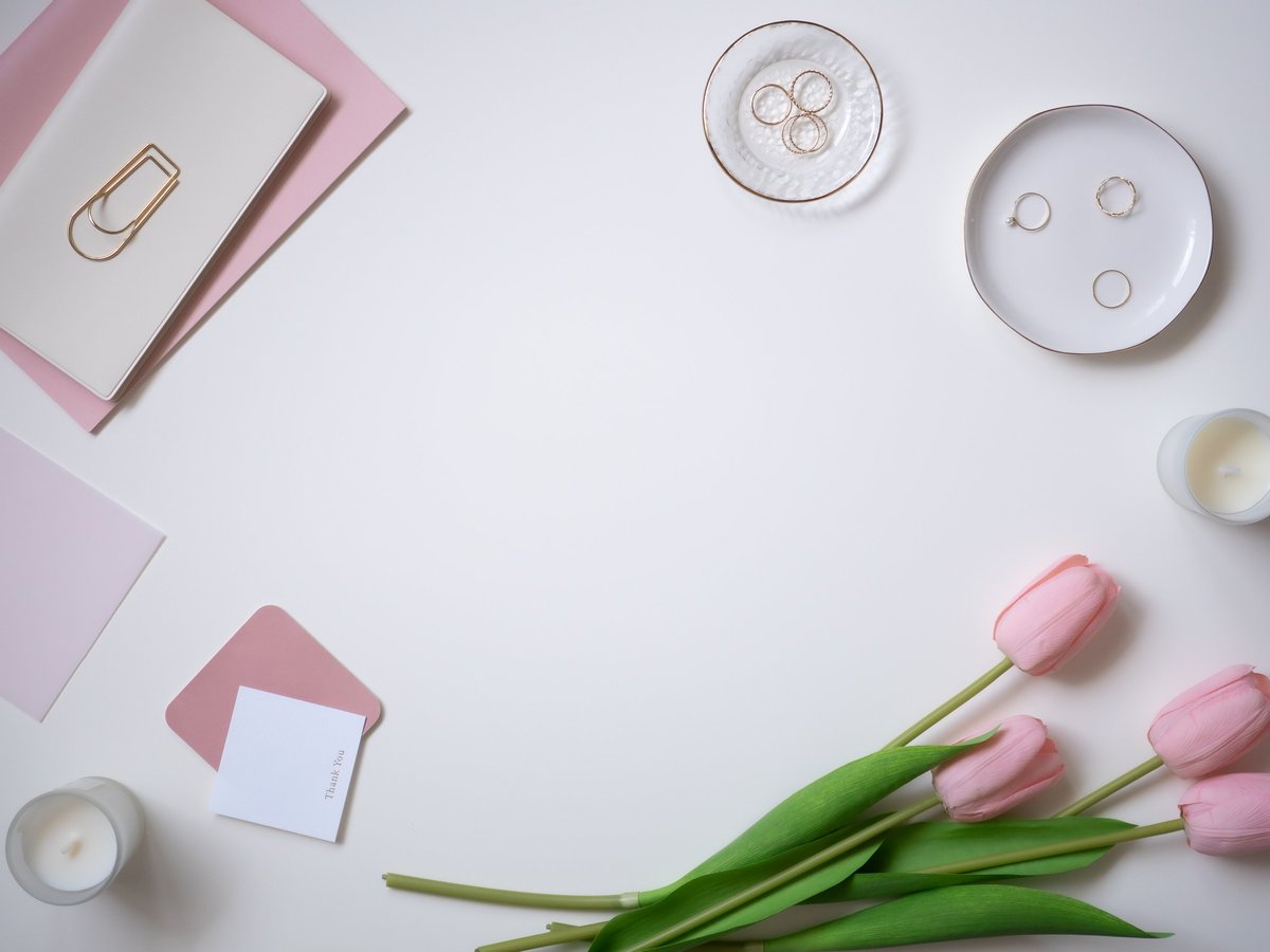 Feminine pink and white desk flat lay used as a design accent
